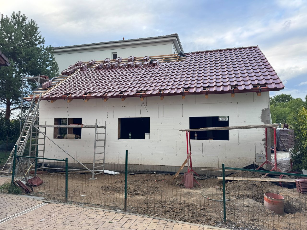 Stavba psího salonu Navi – téměř dokončená střecha s pálenou krytinou a okapy